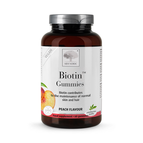 Bottle of New Nordic Biotin Gummies with peach flavor on a white background