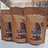 Three packages of Forest Feast salted caramel milk chocolate dates on a white surface.