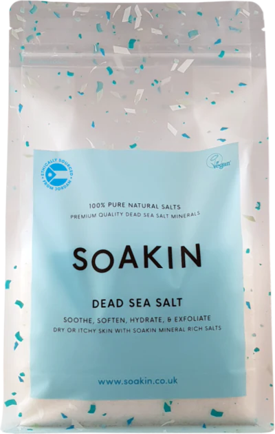 Package of Soakin Dead Sea Salt with branding and product description on a light speckled background