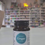 Bottle of Viridian Organic Ginger 400mg capsules on a table with a blurred background