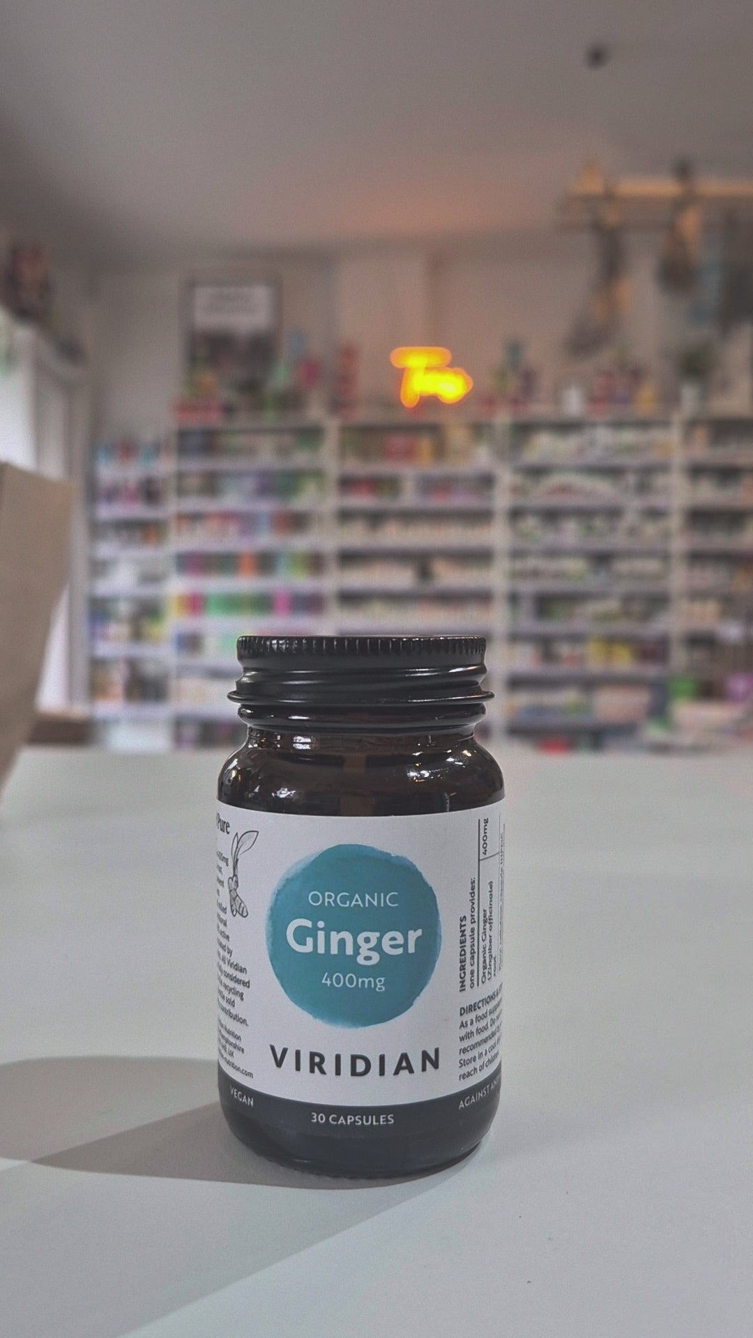 Bottle of Viridian Organic Ginger 400mg capsules on a table with a blurred background
