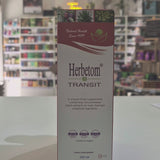 A bottle of Herbetom Transit herbal supplement and its matching cardboard box, displayed on a white shelf in a blurred retail store setting video