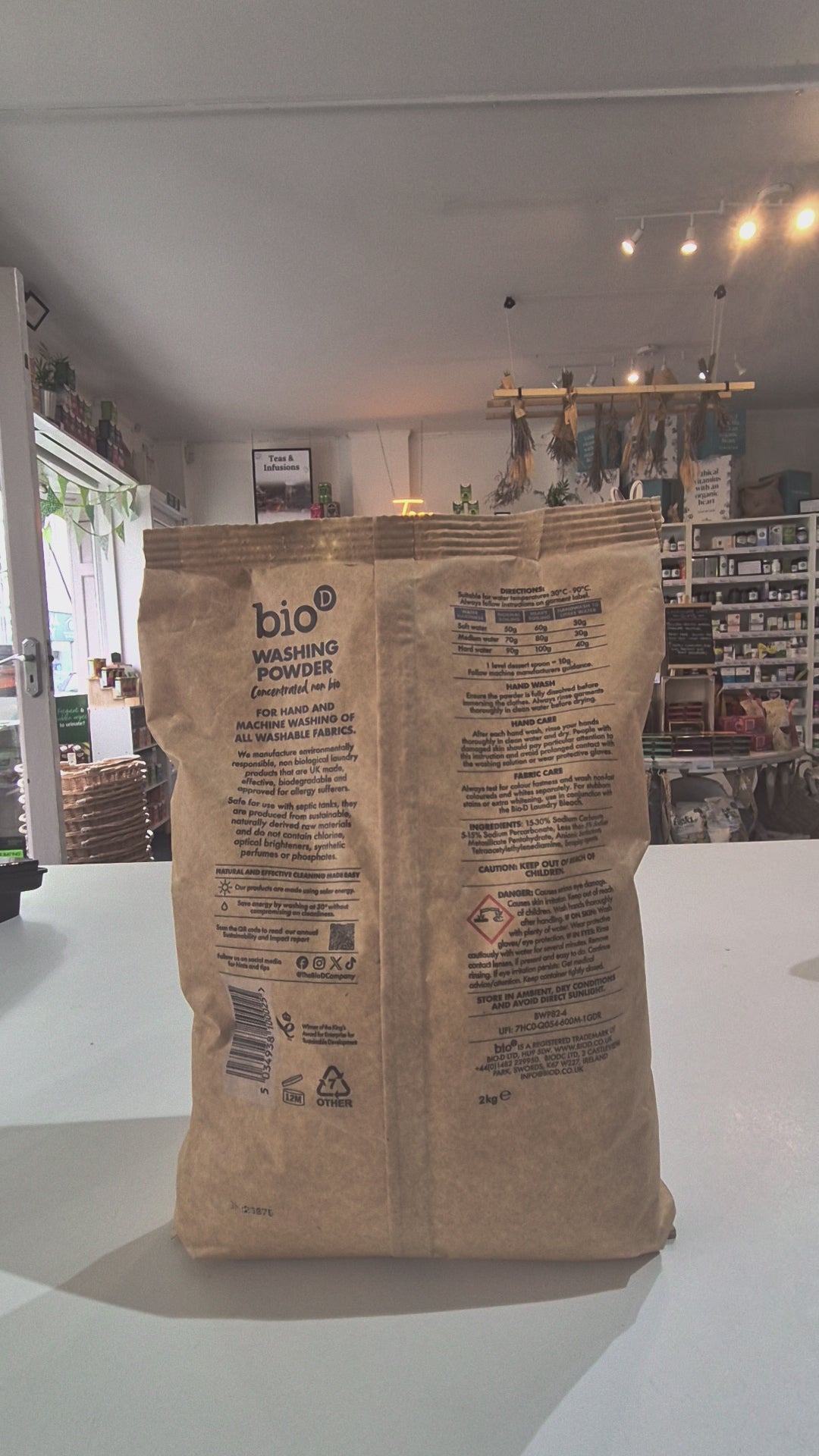 Paper washing powder bag video on a white table 