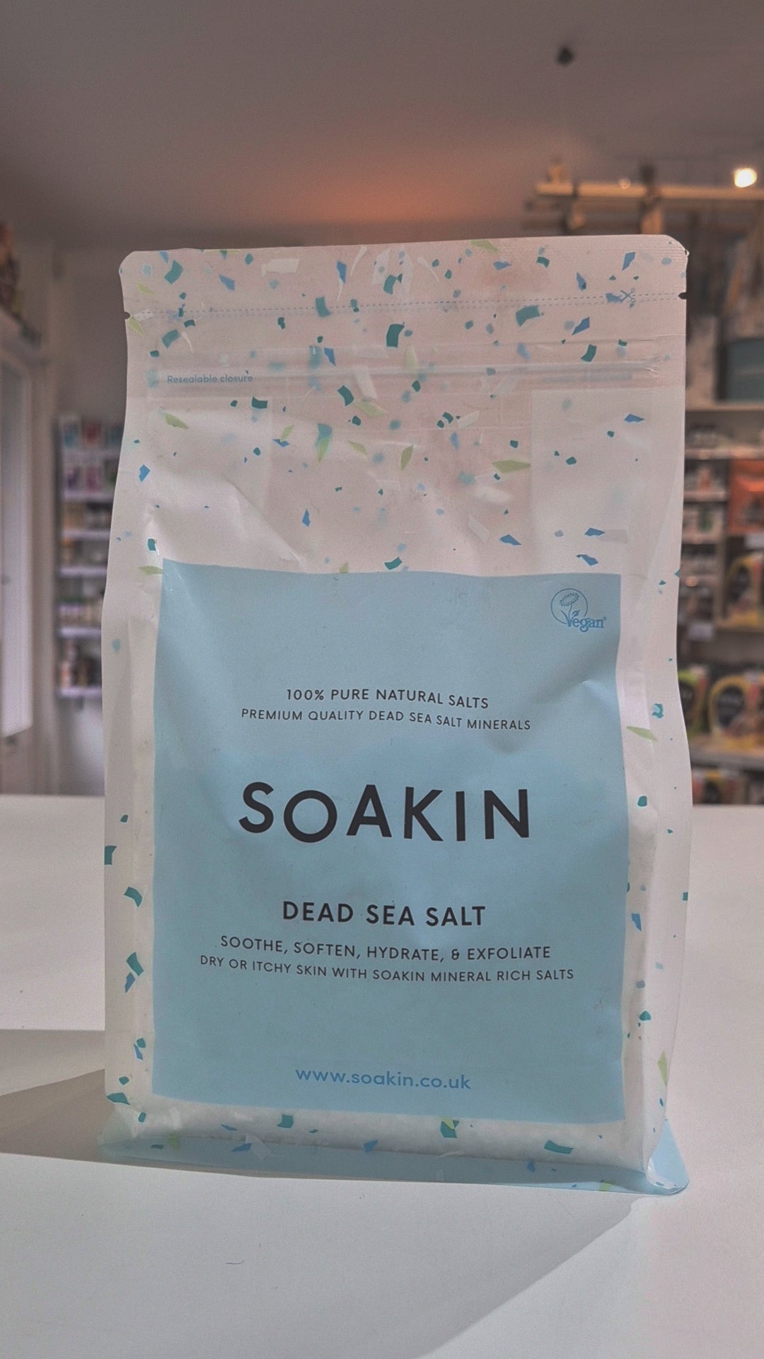 Package of Soakin Dead Sea Salt with branding and product description on a light speckled background video