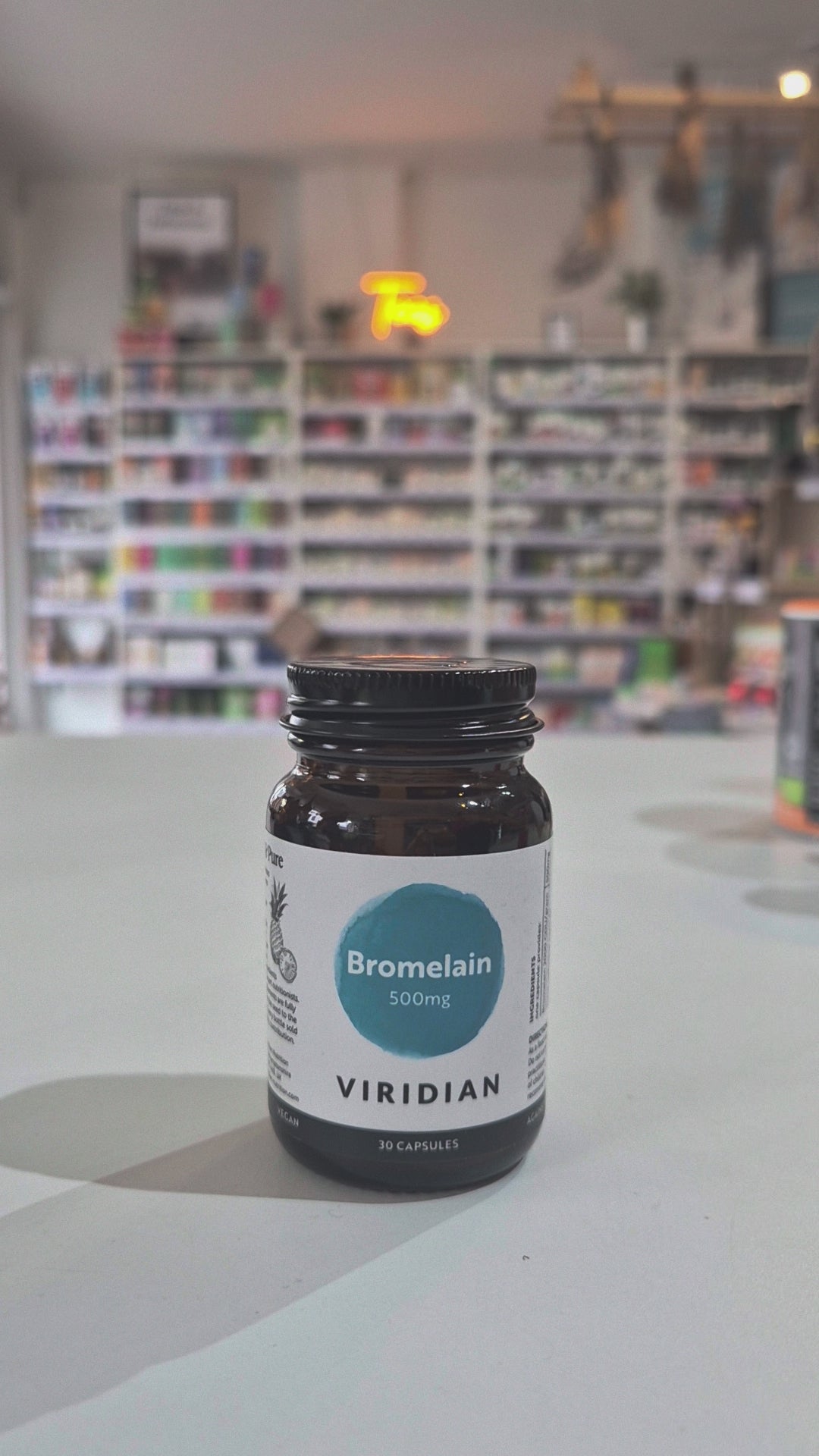 Bottle of Viridian Bromelain 500mg on a counter in a store setting video