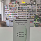 Box of fussy refillable natural deodorant on a white surface with a blurred background