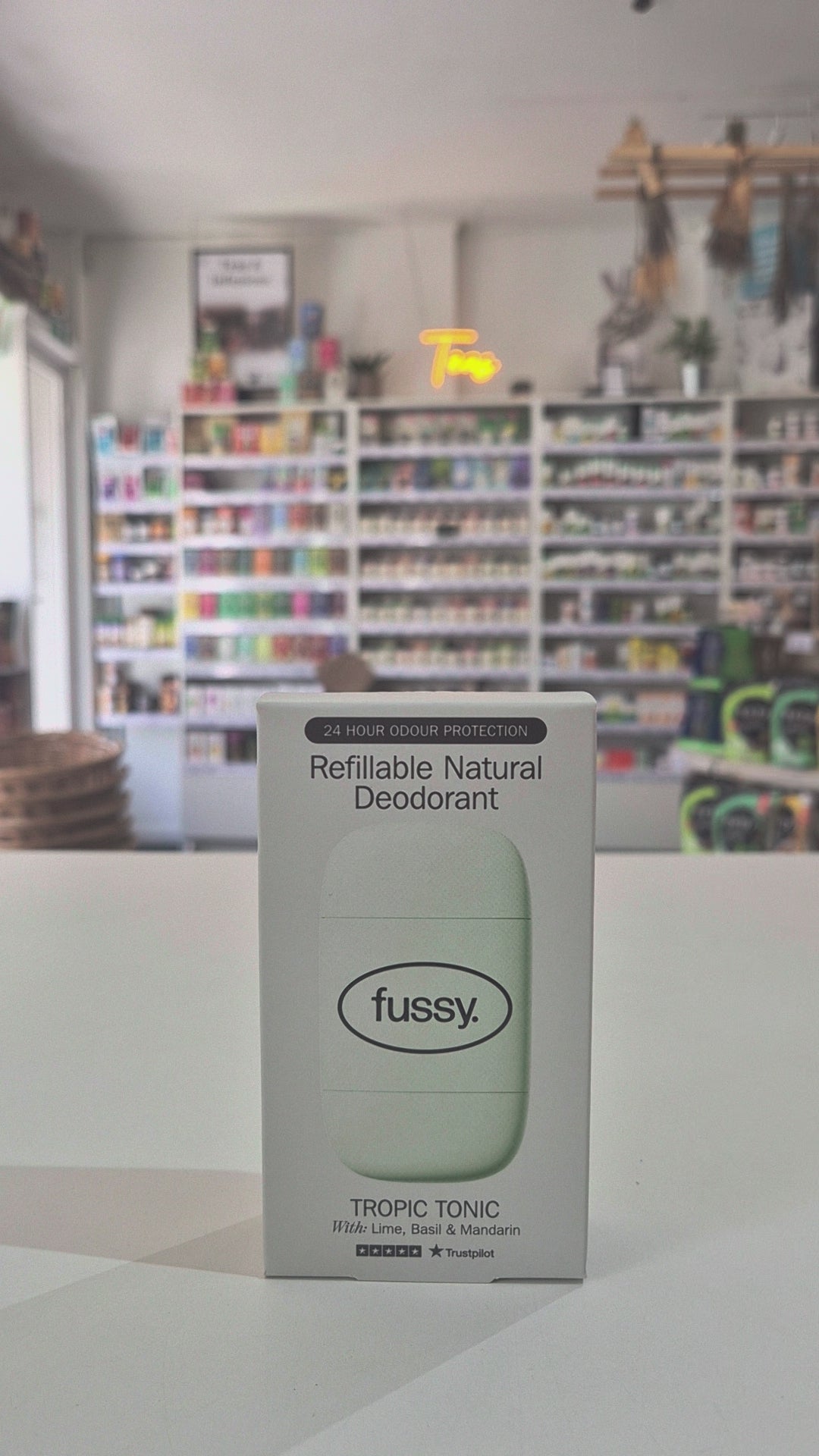 Box of fussy refillable natural deodorant on a white surface with a blurred background