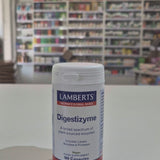 Lamberts Digestizyme supplement container on a white surface with a blurred background