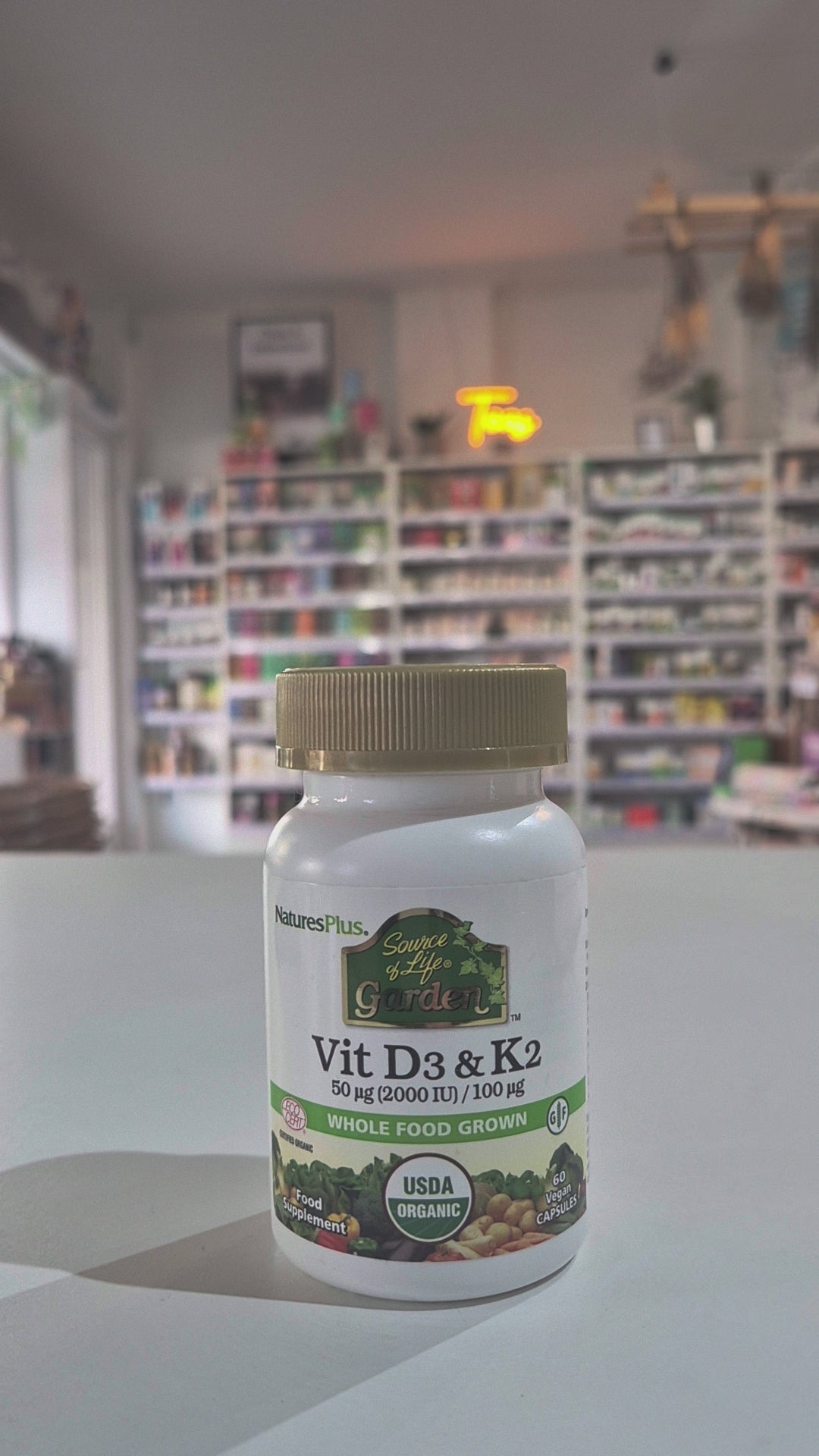 Vitamin supplement bottle labeled 'Vit D3 & K2' by NaturesPlus on a shop background as a video
