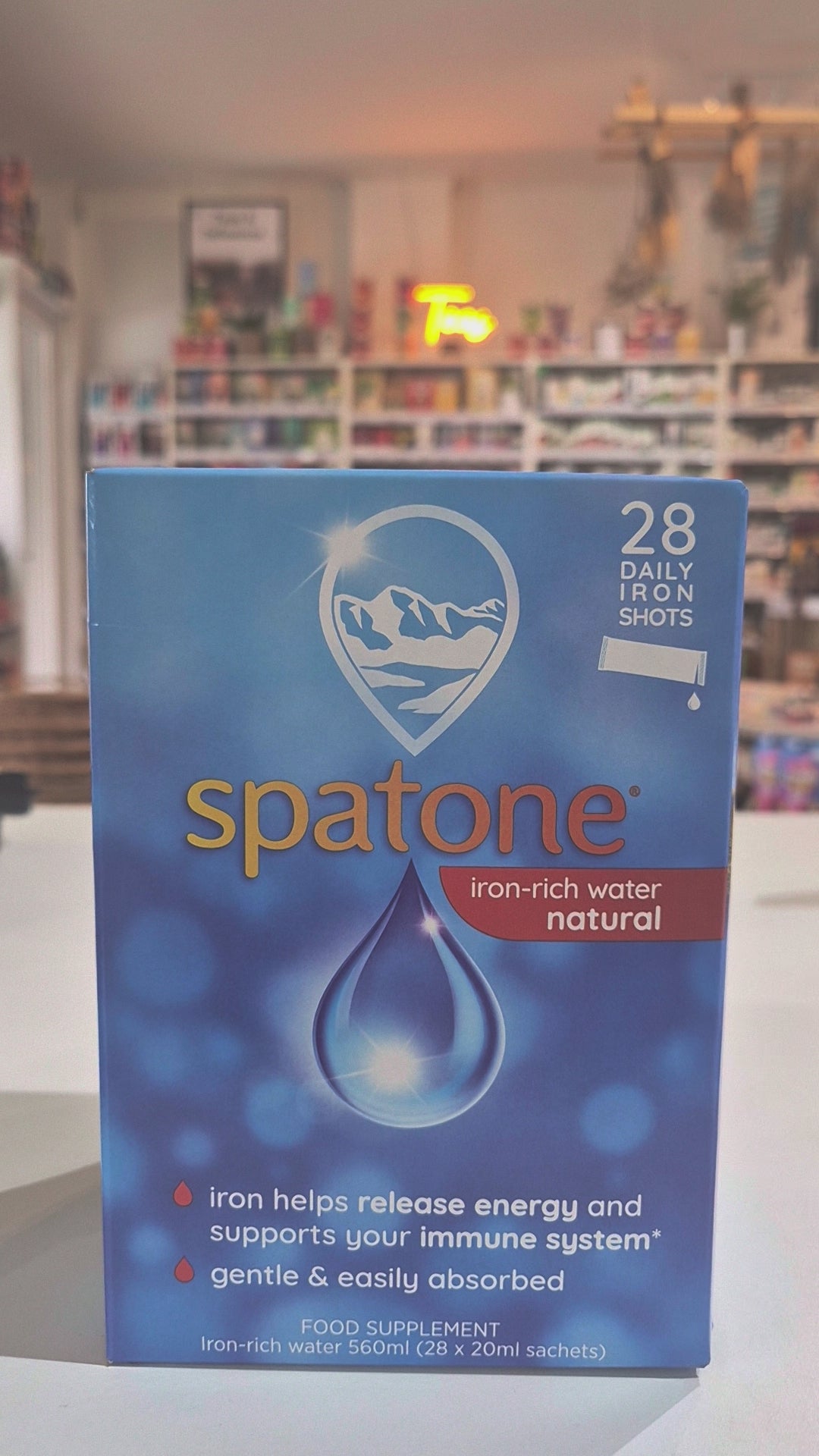 Box of Spatone Iron+ 28 Day Sachets, iron-rich water supplement, with mountain and water droplet imagery