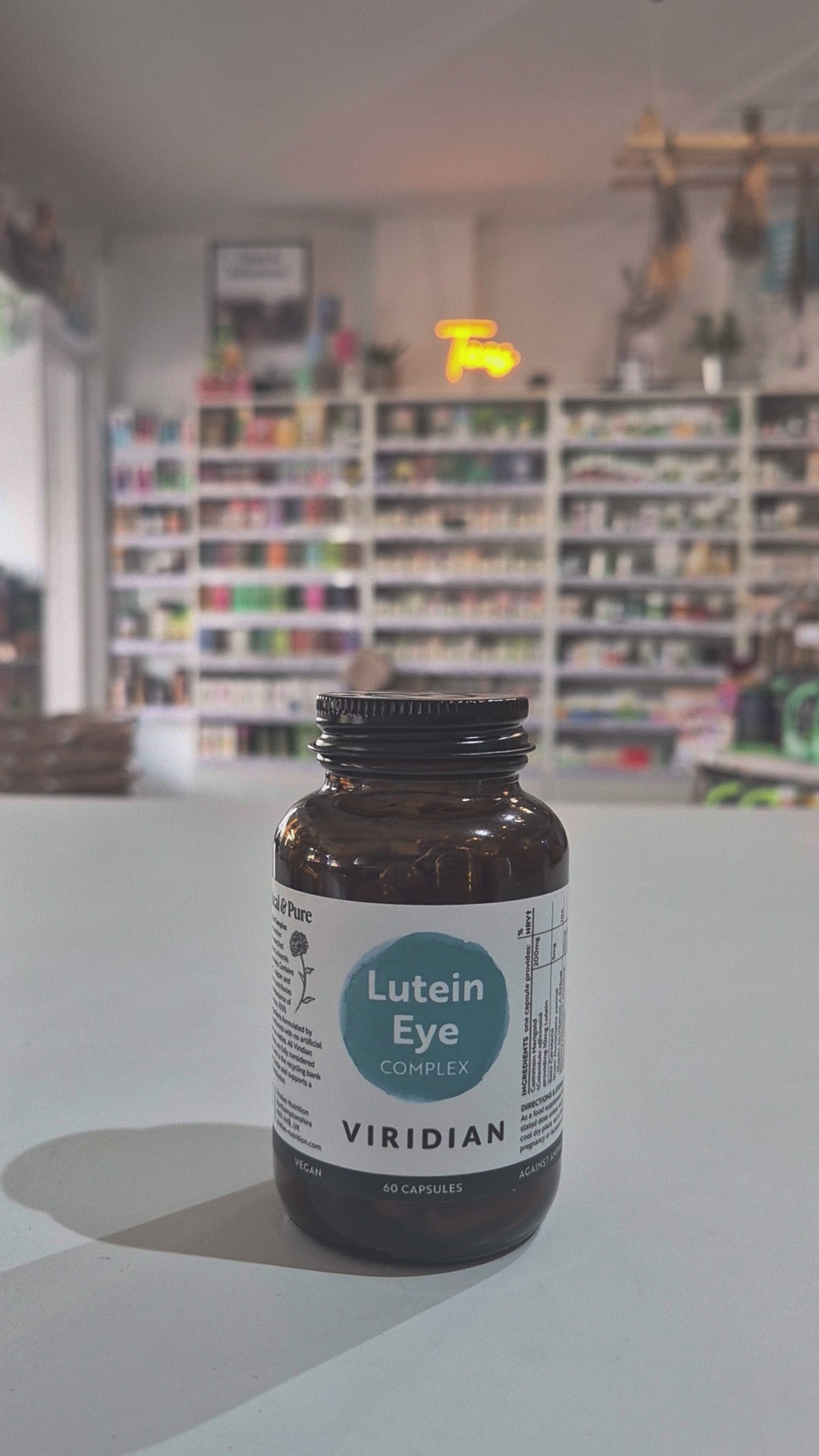 Bottle of Viridian Lutein Eye Complex on a counter with a blurred store background Video