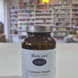 A bottle of Biocare Calcium Citrate containing 90 capsules for bone and muscle support in a shop setting video