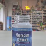 A bottle of Nature's Plus Magnesium Glycinate supplement with 90 capsules, labeled for supporting cardiovascular health, nerve & muscle relaxation, and overall psychology function.