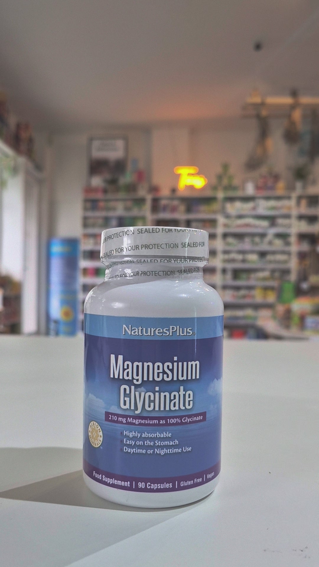 A bottle of Nature's Plus Magnesium Glycinate supplement with 90 capsules, labeled for supporting cardiovascular health, nerve & muscle relaxation, and overall psychology function.