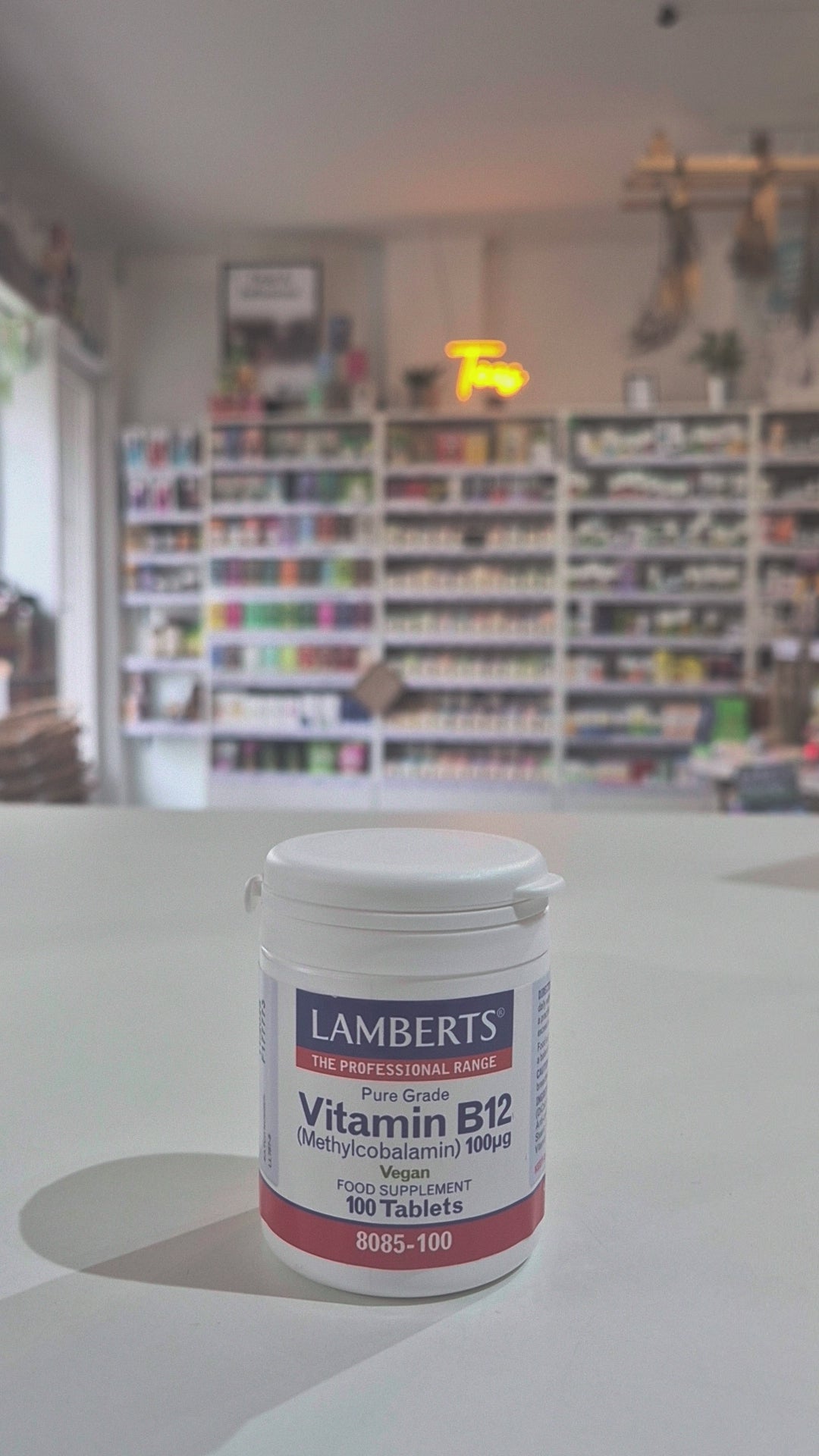 Lamberts Vitamin B12 supplement container on a table with a blurred background, in a shop setting video