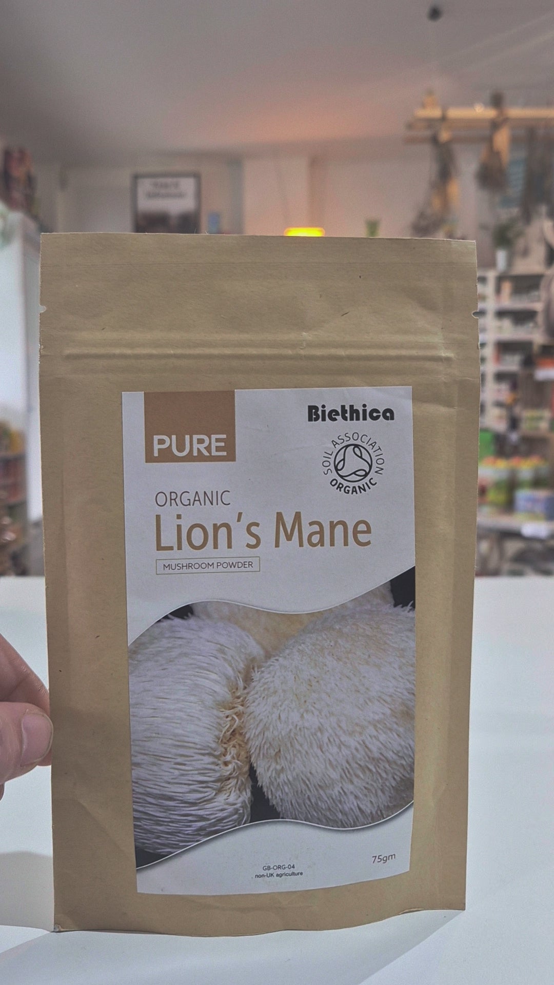 Package of Biethica Pure Organic Lion's Mane mushroom powder in a store setting