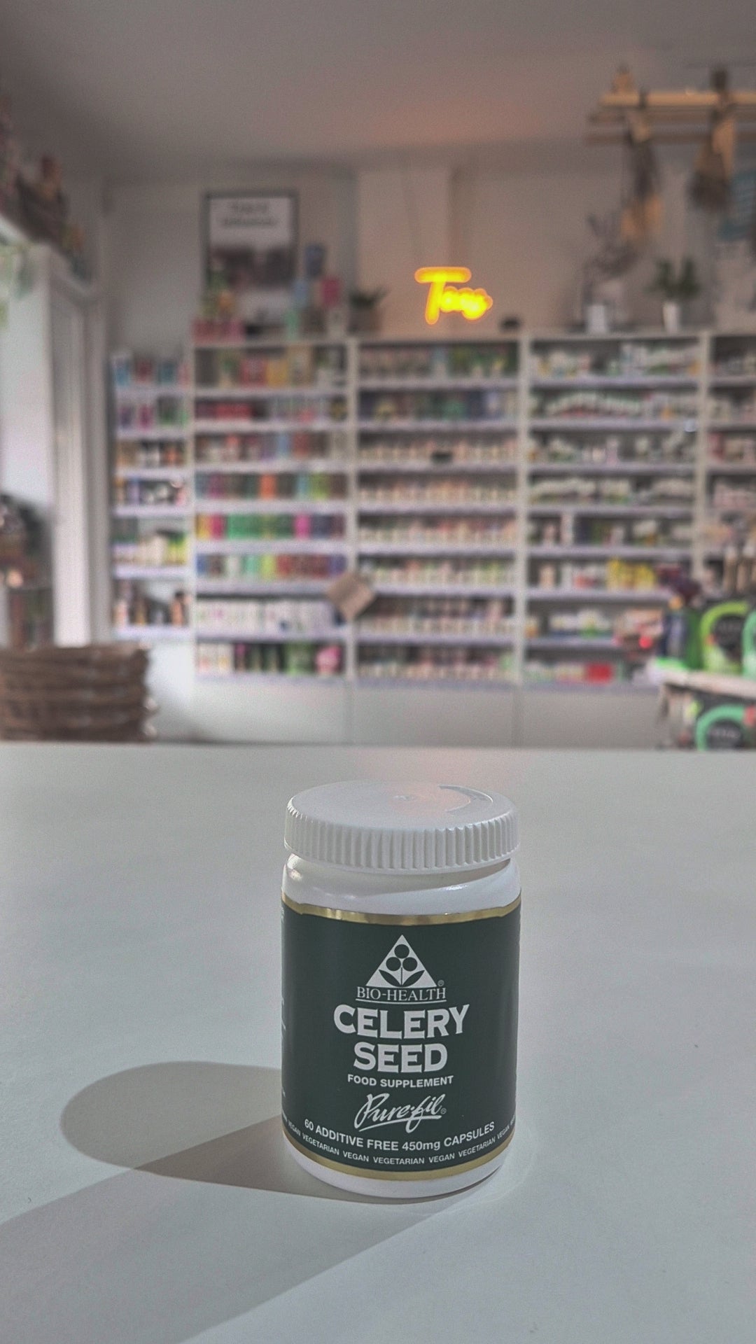 A bottle of Bio Health Celery Seed dietary supplement containing 60 capsules, with a green and white label, indicating the product is vegan and free from additives Video