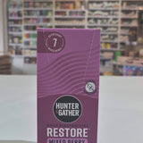 Purple box of Hunter & Gather Restore Mixed Berry electrolytes with a blurred store interior in the background