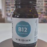 Jar of Viridian High Twelve B12 B Complex supplement on a white surface with a blurred store background video. 