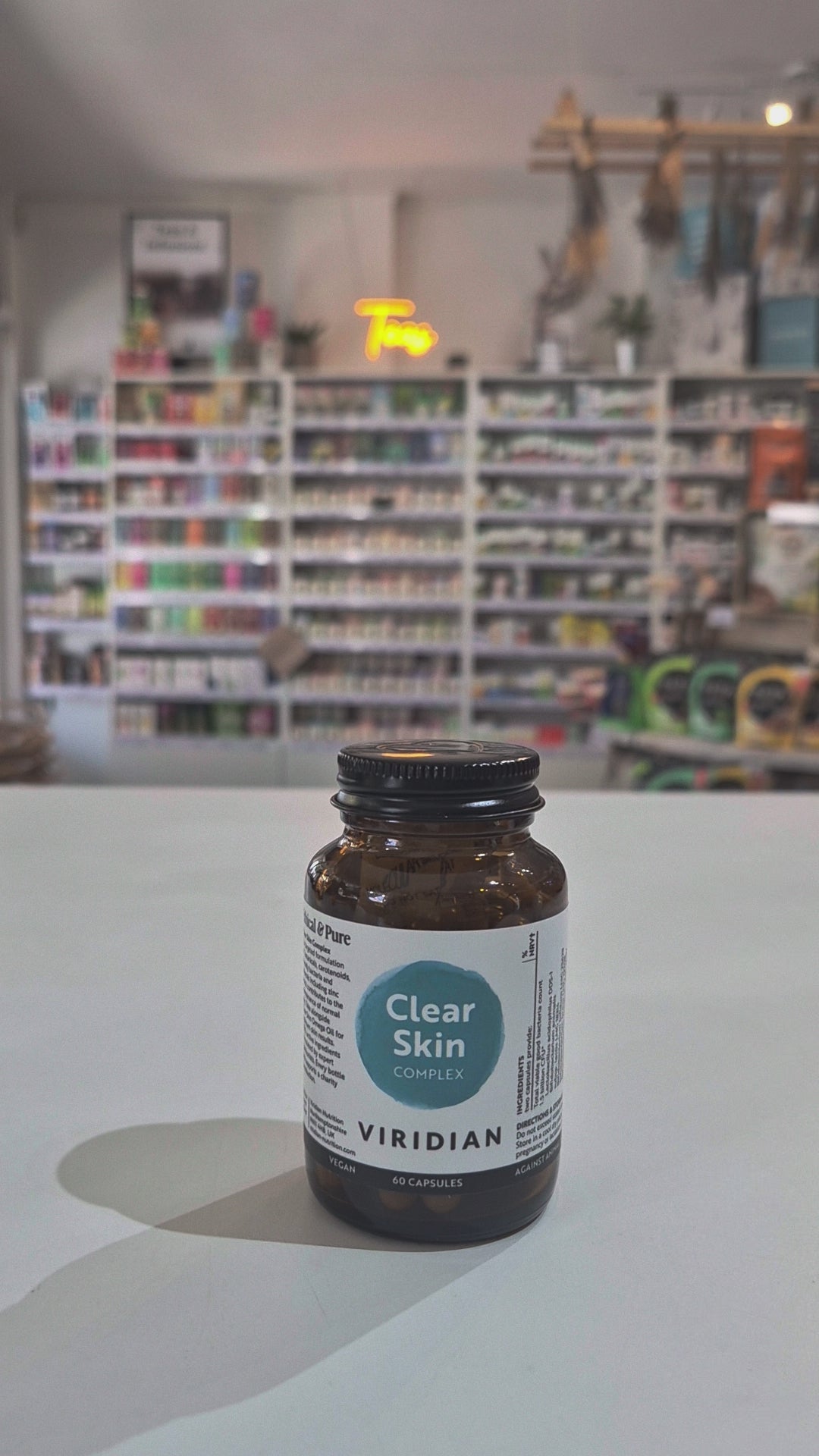 Brown supplement bottle labeled 'Clear Skin Complex' by Viridian on a white surface video