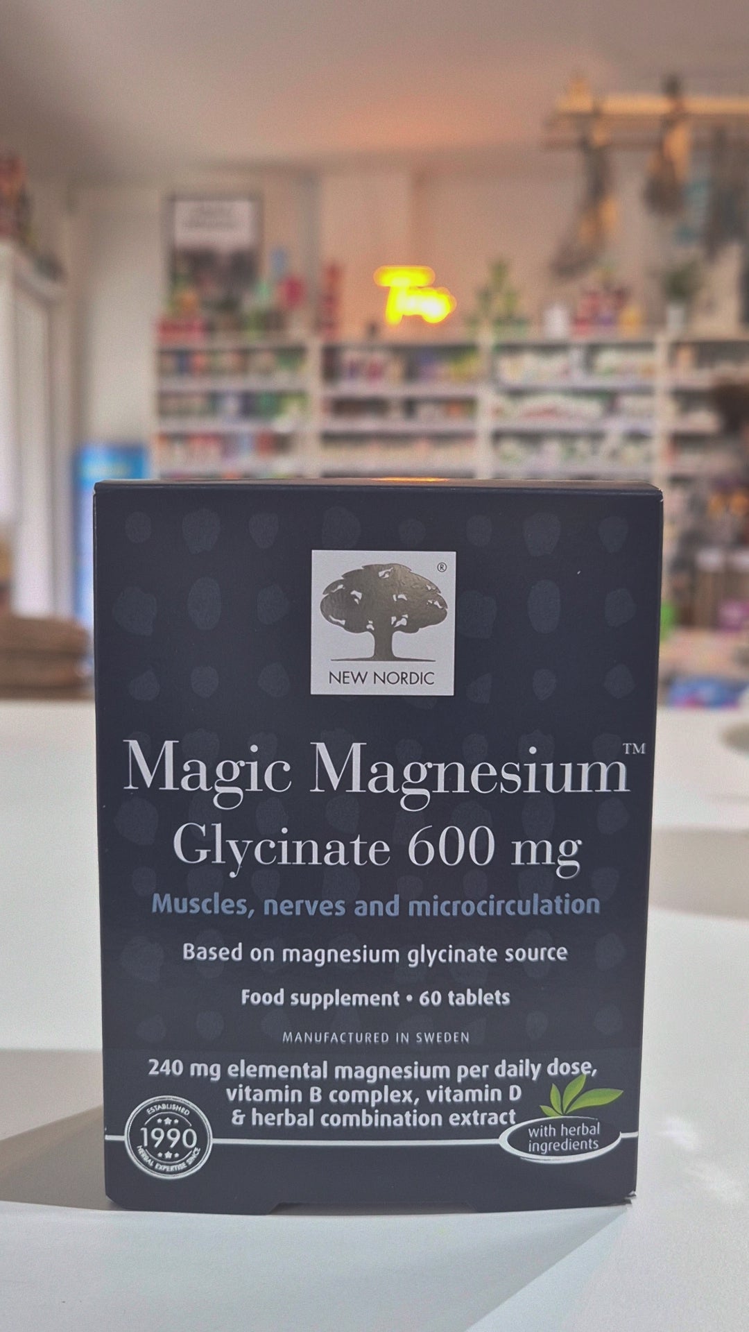 Box of New Nordic Magic Magnesium Glycinate 600 mg supplement on a blurred store shelf background