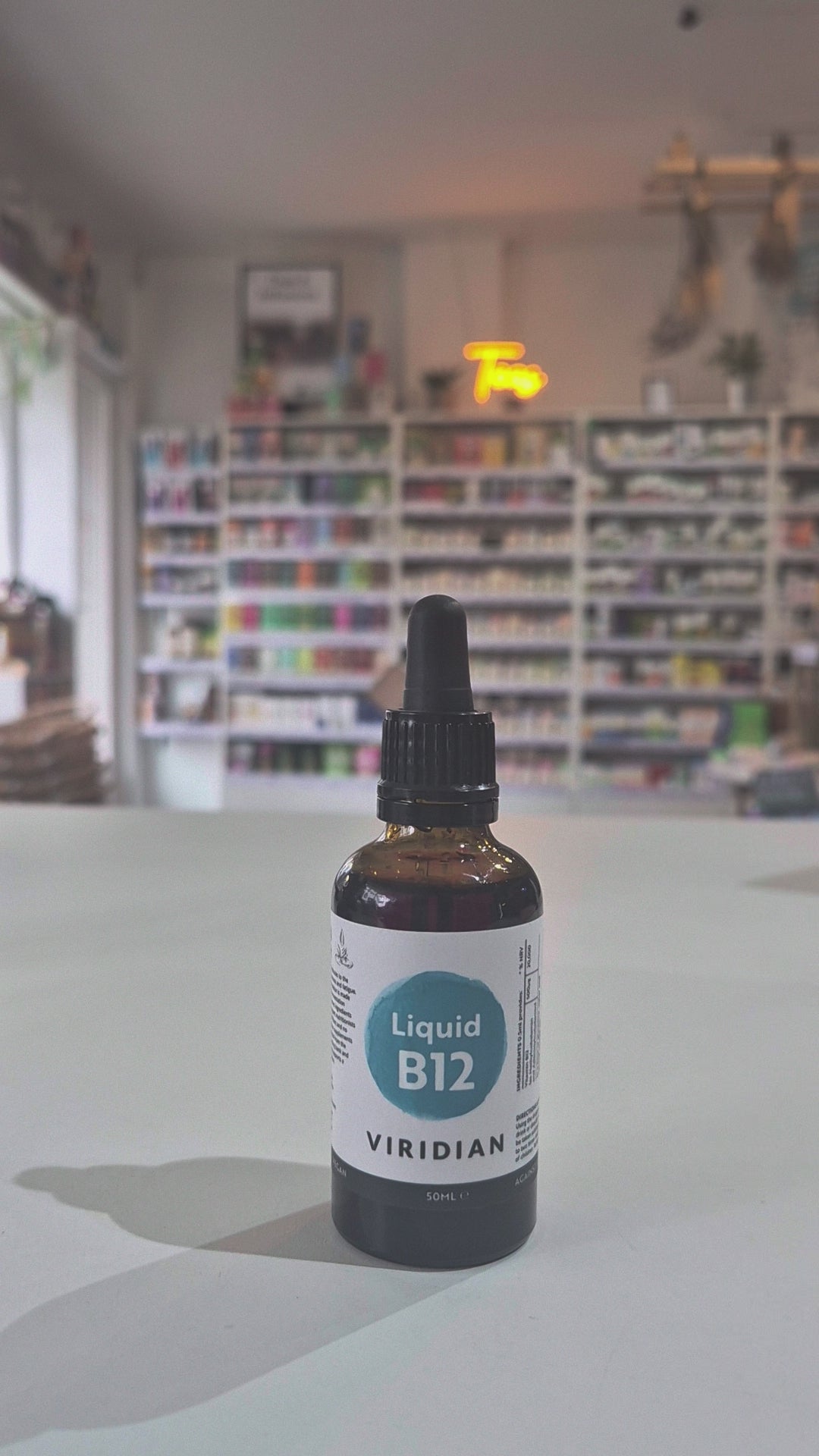 Bottle of Viridian Liquid B12 on a table with a blurred store background video