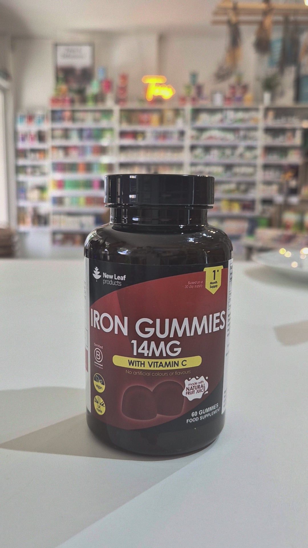 Bottle of Iron Gummies with Vitamin C on a counter in a store setting