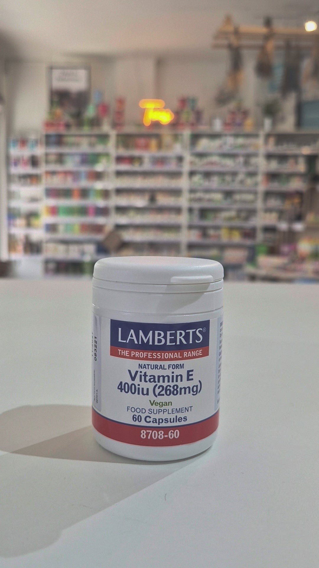 A container of Lamberts Vitamin E supplement with 60 capsules, indicating 400iu (268mg) strength, and marked as vegan.