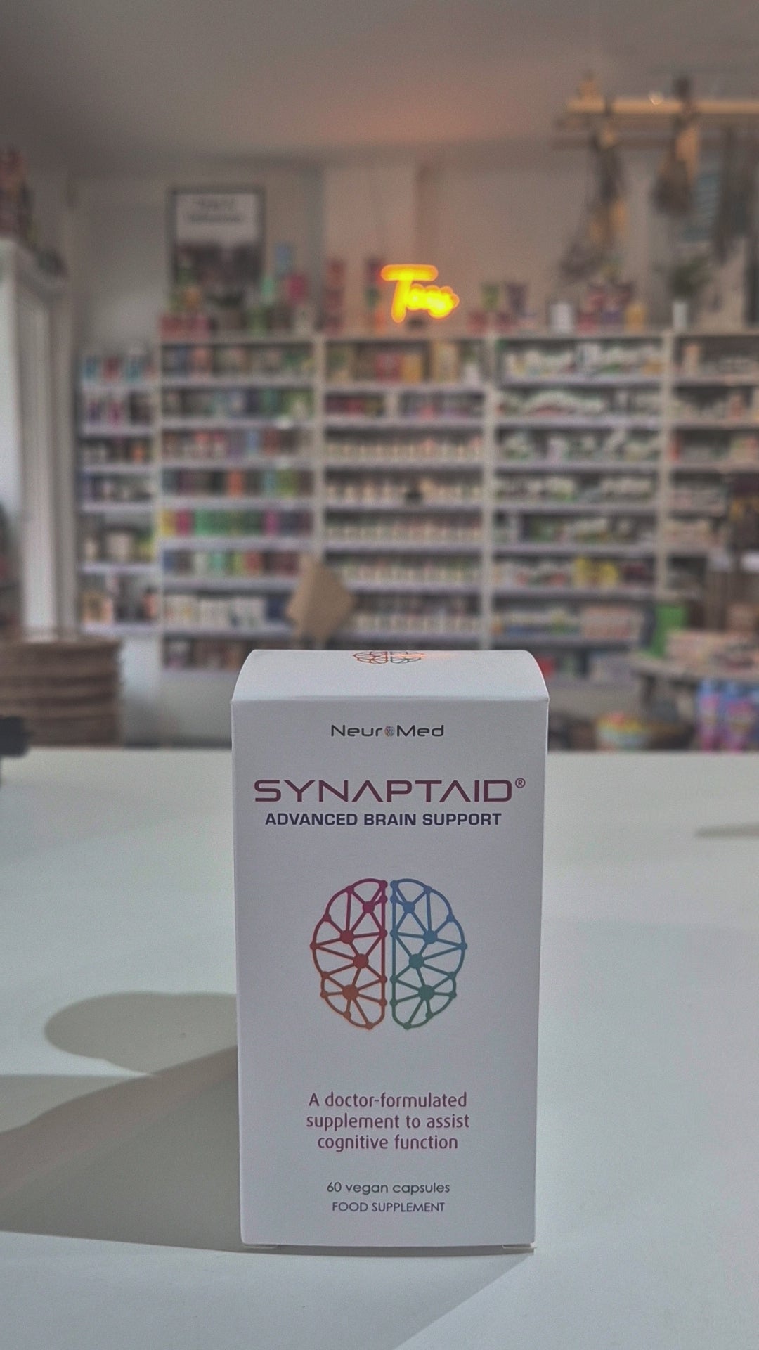 A bottle of Synaptaid Advanced Brain Support supplement with its packaging box, displaying the product name and brief description.
