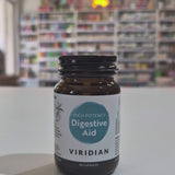 Bottle of Viridian High Potency Digestive Aid on a white surface with a blurred background