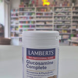 Lamberts Glucosamine Complete supplement container on a table with a blurred store background