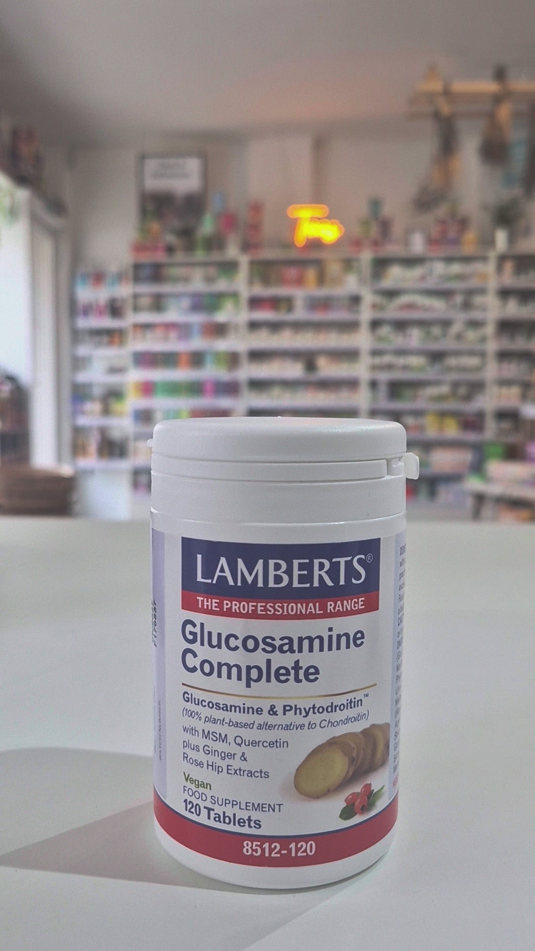 Lamberts Glucosamine Complete supplement container on a table with a blurred store background
