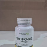 Nature's Plus Shot-O-B12 5000 Mcg lozenge in a white bottle with green and purple label, indicating wild berry flavour and dietary supplement category in a shop video