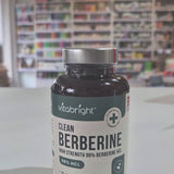 Vitabright Clean Berberine supplement bottle on a table with a blurred background video. 