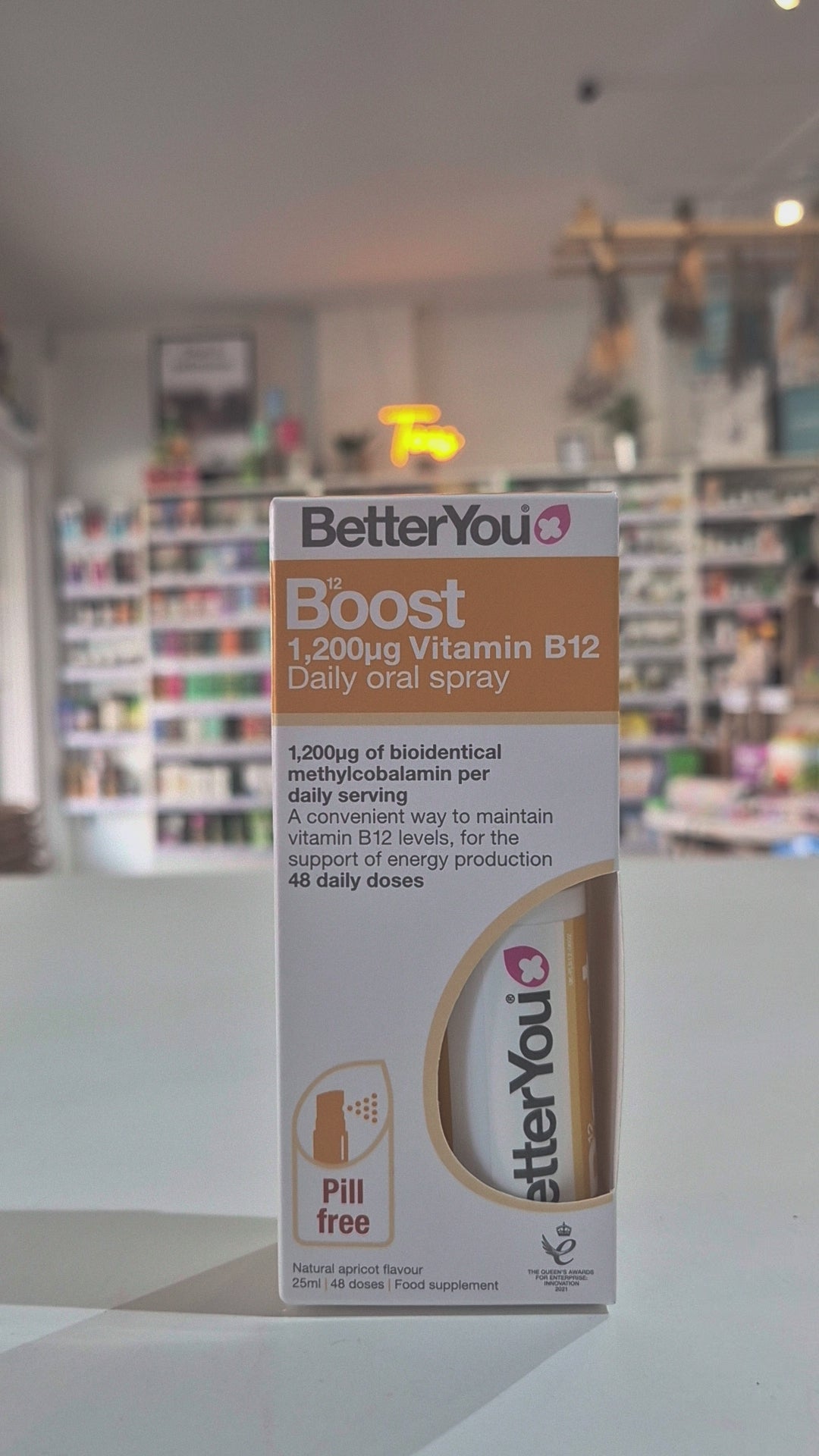 Packaging of Better You Boost B12 Oral Spray, showing the spray bottle and box with branding and product information in a shop video
