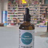 Bottle of Viridian Ionic Magnesium Liquid on a counter with a store background