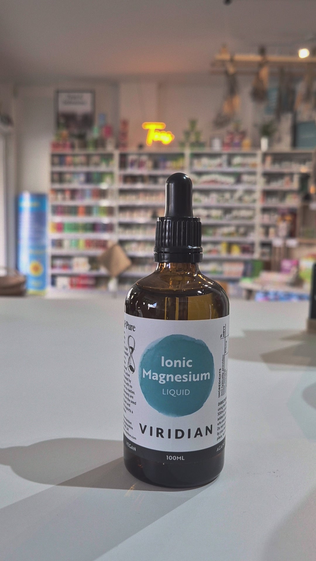 Bottle of Viridian Ionic Magnesium Liquid on a counter with a store background