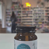 Vitamin B3 supplement bottle with 'Viridian' label on a blurred store background.