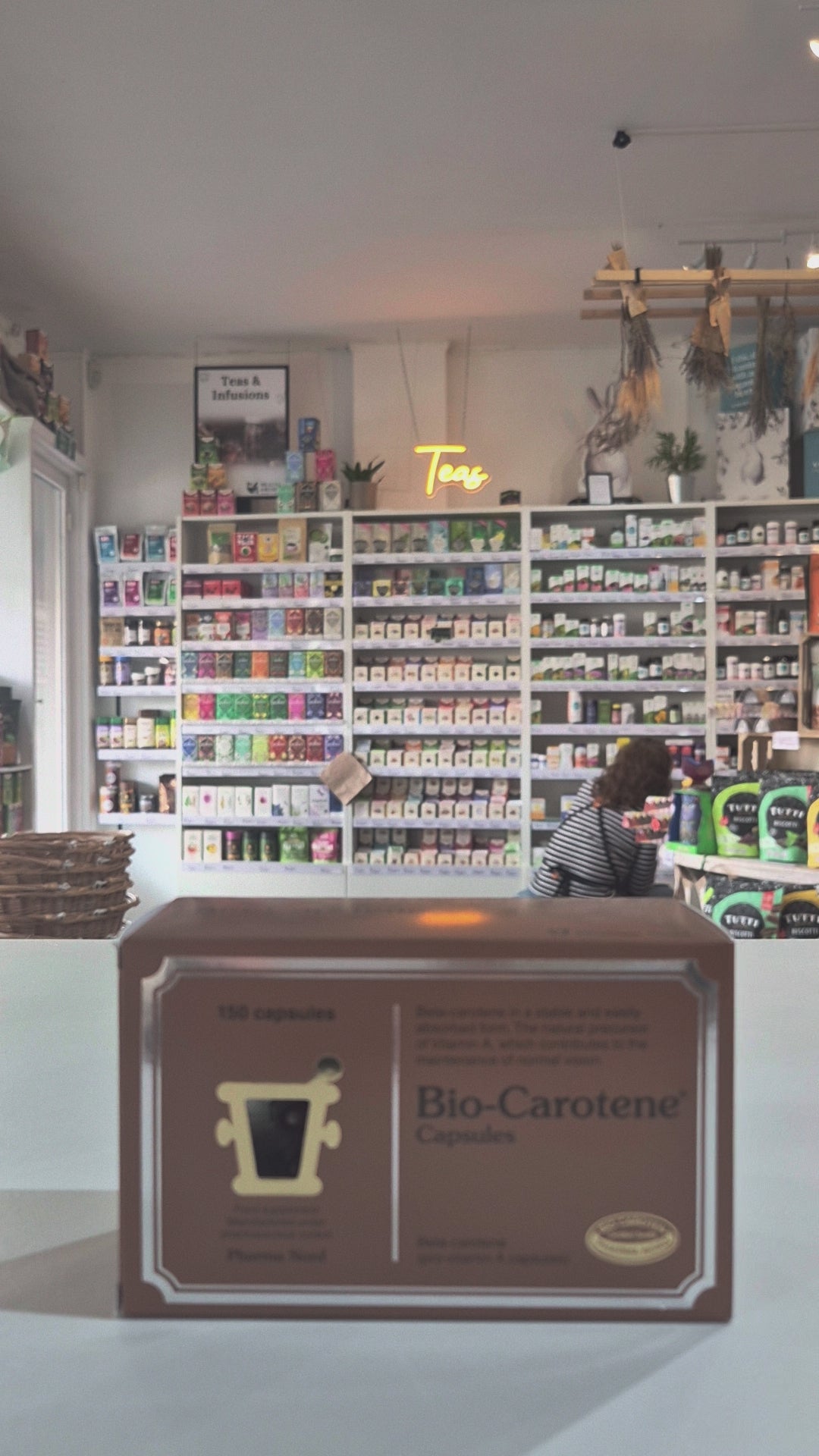 Box of Bio-Carotene Capsules on a counter with a store shelf in the background video
