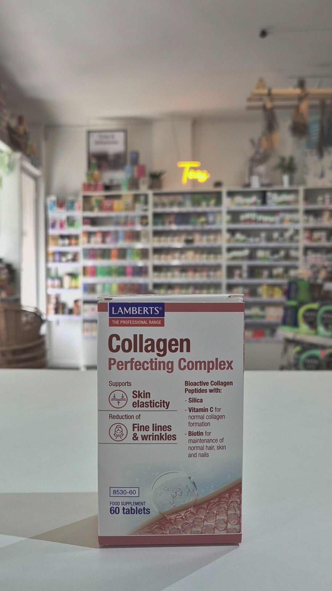 This image displays a package of Lamberts Collagen Complex, which contains 60 tablets aimed at supporting skin elasticity and reducing fine lines and wrinkles. The package is professionally designed, featuring a clear and informative graphic that illustrates the product's benefits and key ingredients.