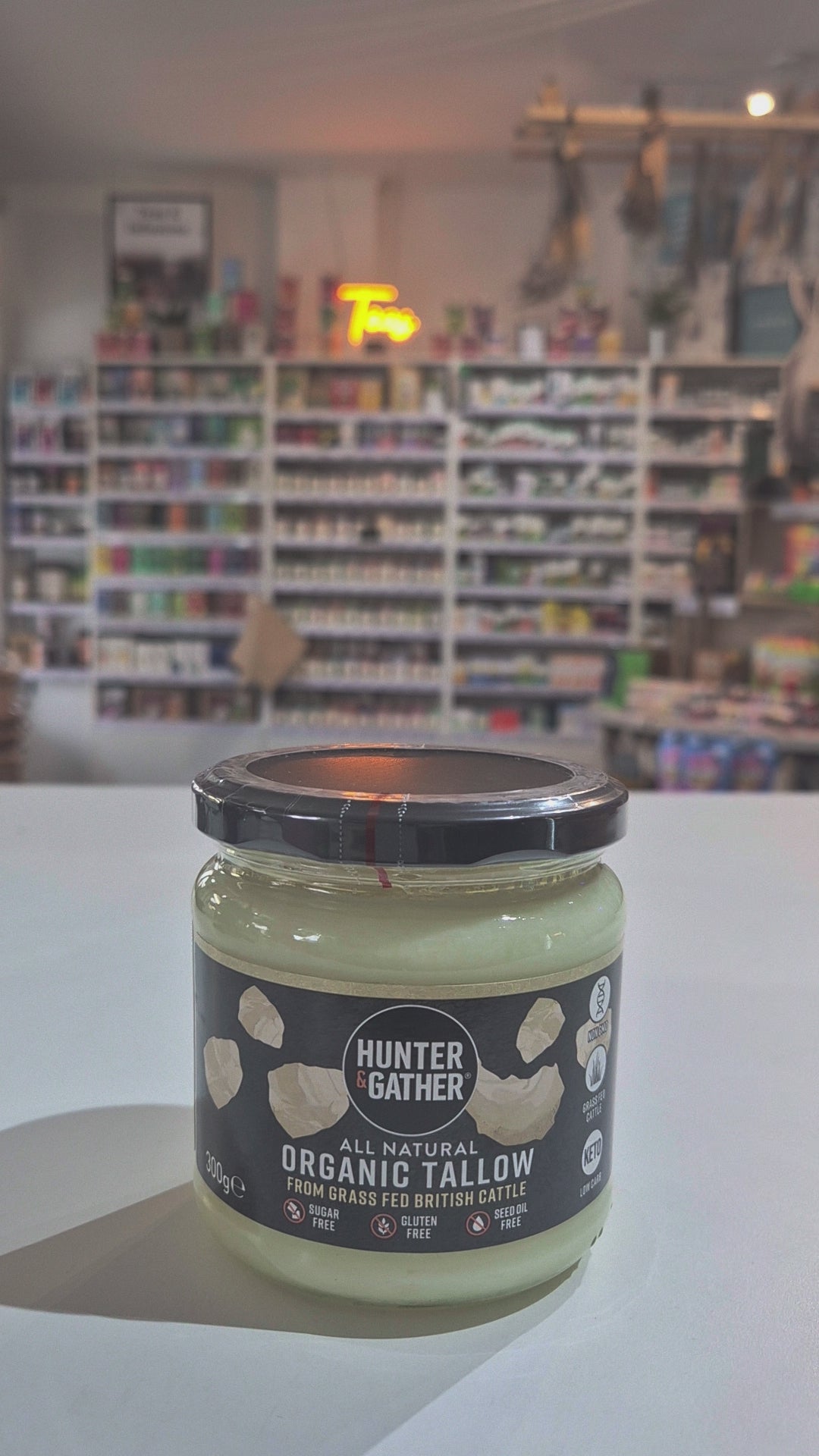 Jar of organic Hunter & Gather all-natural Organic Tallow on a white surface with a blurred background