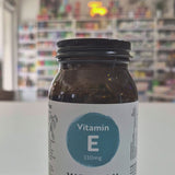 Jar of Viridian Vitamin E capsules on a white surface with a blurred store background