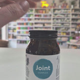 Jar of Viridian Joint Complex on a white surface with a blurred store background