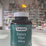 Lifeplan Dietary Fibre 440mg supplement bottle on a counter with a store background