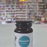 Bottle of Viridian Boswellia on a white surface with a blurred background