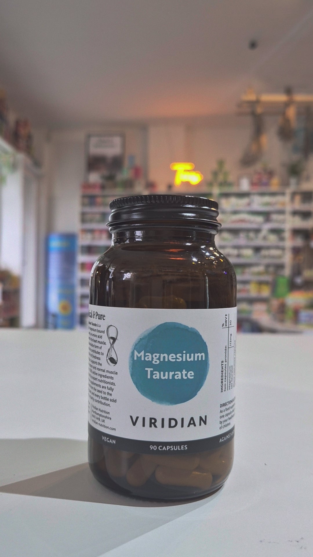 Bottle of Viridian Magnesium Taurate on a counter in a store setting