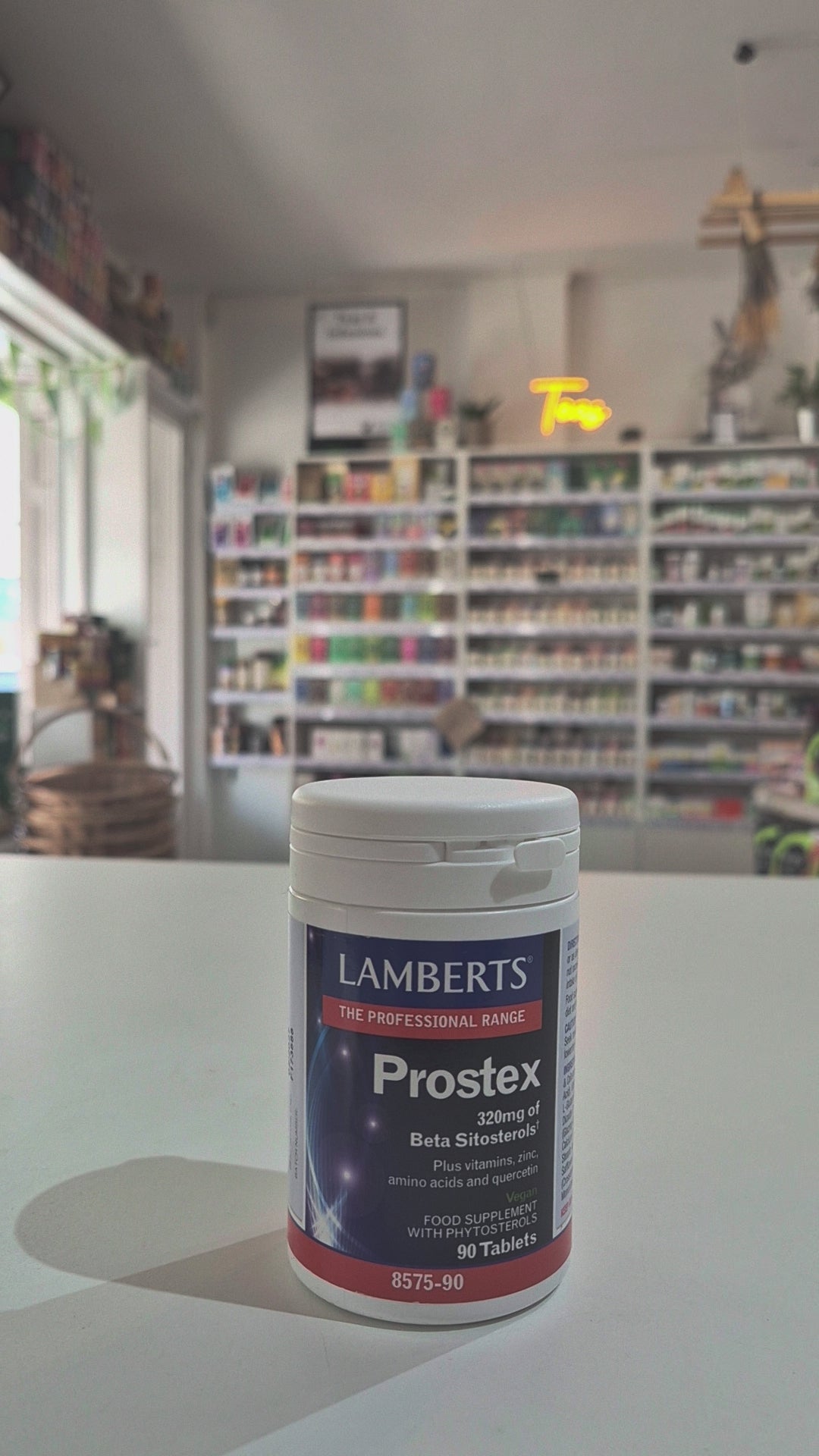 A bottle of Lamberts Prostex, which contains 320mg of beta sitosterols, vitamins, zinc, amino acids, and quercetin. The bottle is labeled with the product name and number of tablets, 90 tablets, and it's part of the professional range video. 