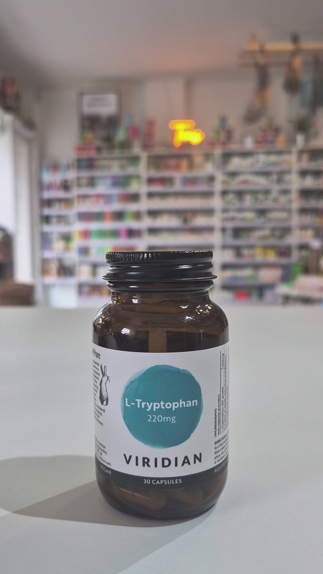 Bottle of Viridian L-Tryptophan on a shelf with a blurred store background