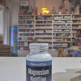 NaturesPlus Magnesium NightTime supplement bottle on a store shelf background