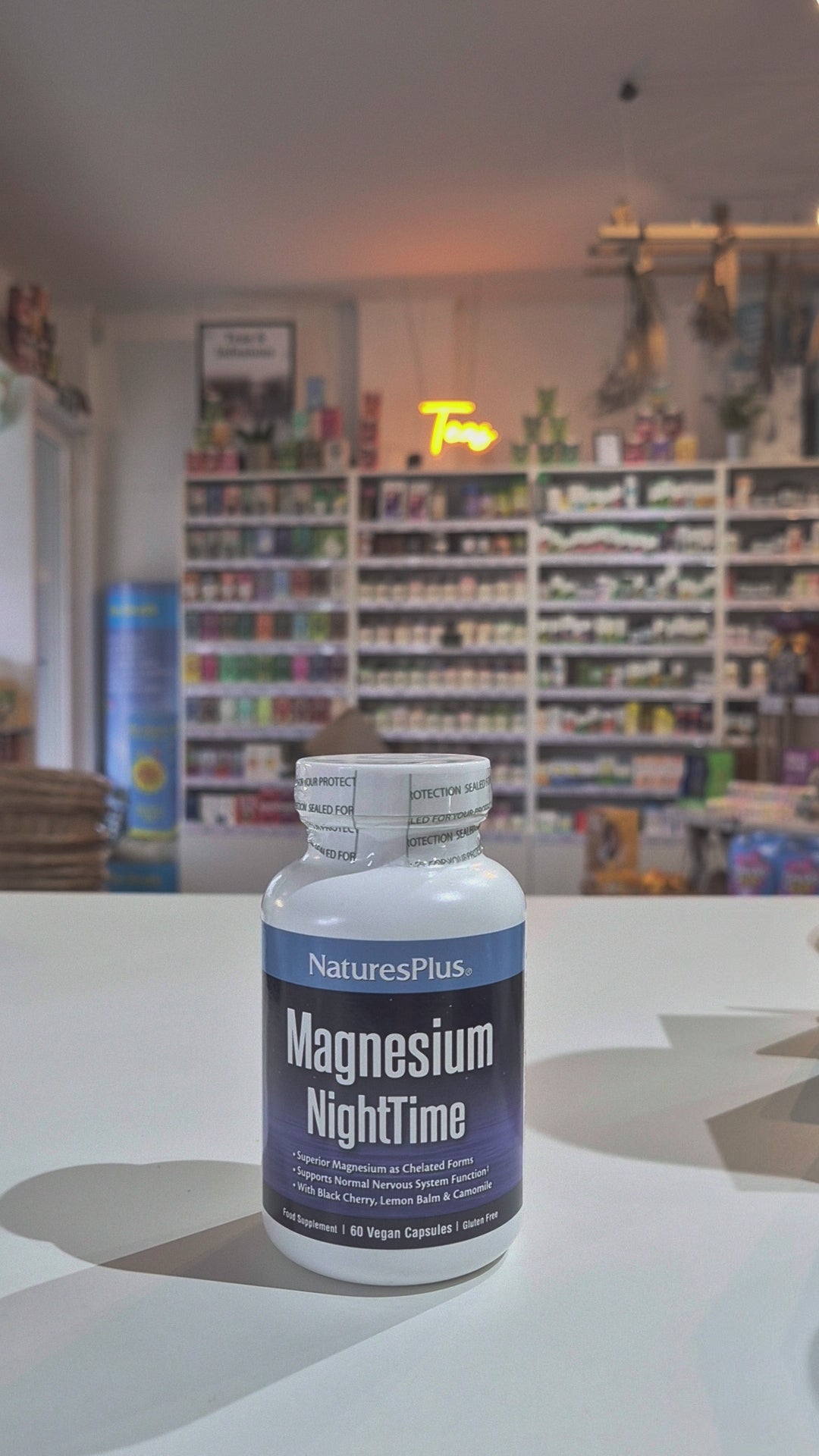 NaturesPlus Magnesium NightTime supplement bottle on a store shelf background